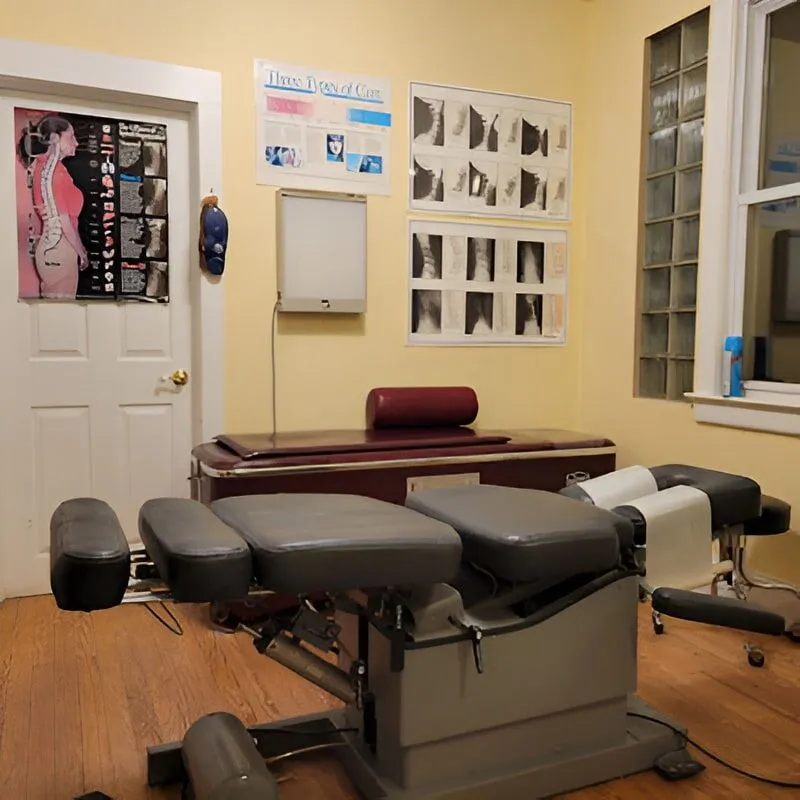 Chiropractic adjustment table ready for patient care in the treatment room.