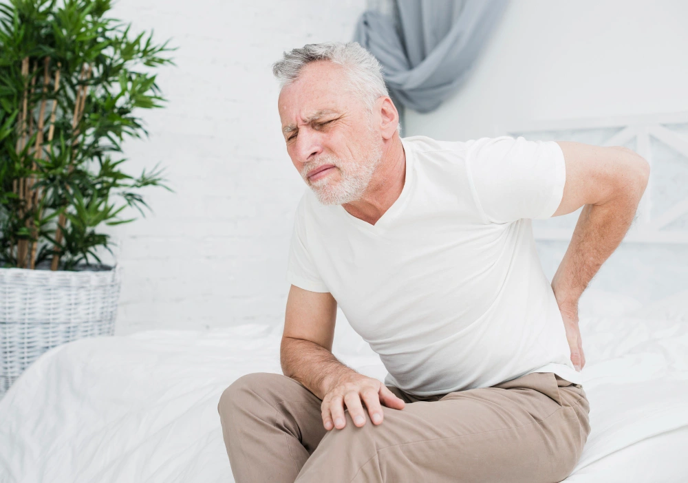 Elderly man suffering severe herniated disc back pain in Freehold NJ