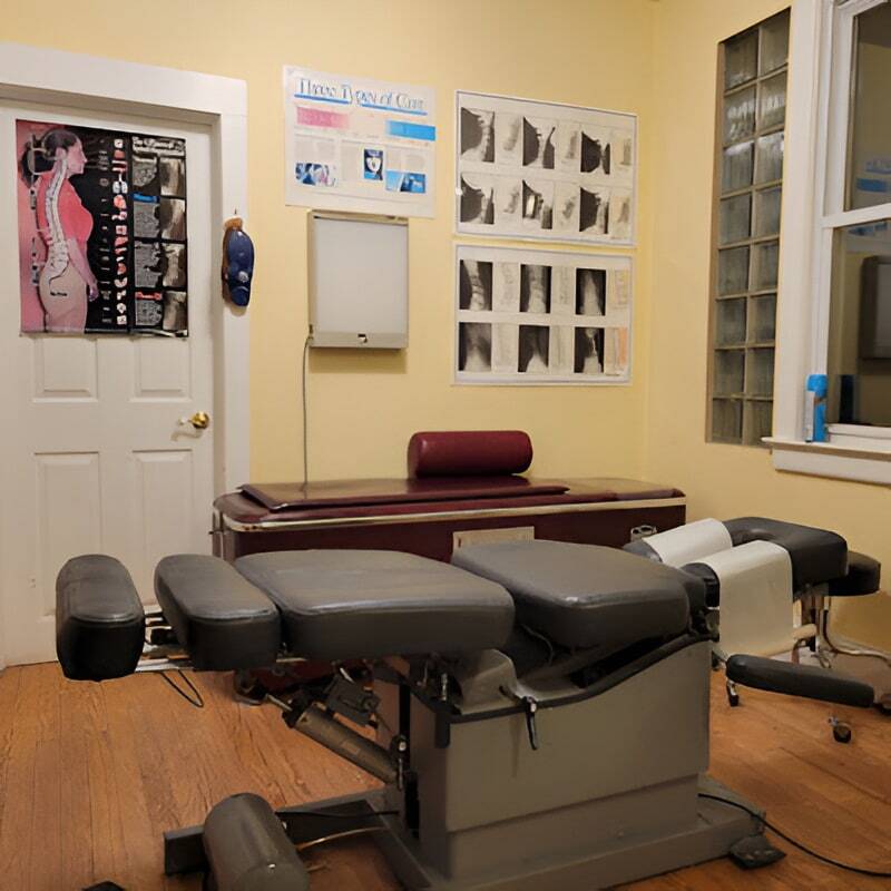 Chiropractic adjustment table ready for patient care in the treatment room.