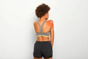 Woman holding shoulder from rotator cuff injury pain