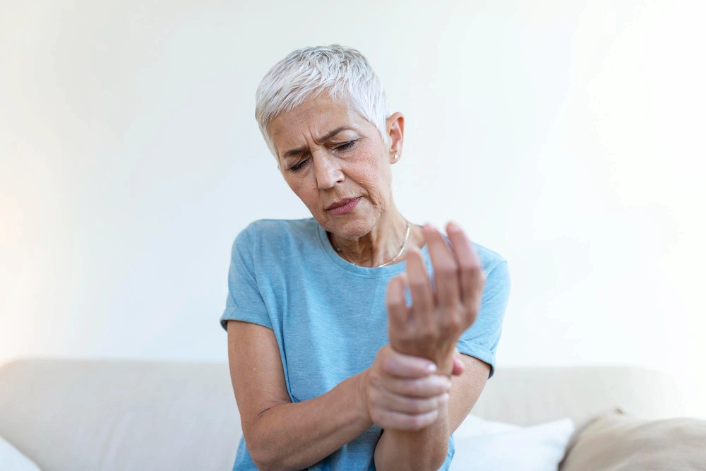 Elderly woman experiencing arthritis joint pain
