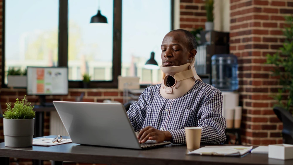 Worker experiencing injury pain receiving chiropractic care