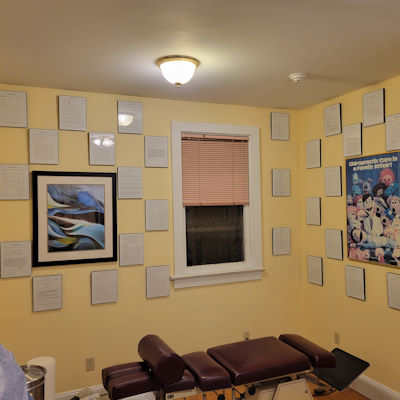 Wall display of thank-you letters from happy chiropractic patients.