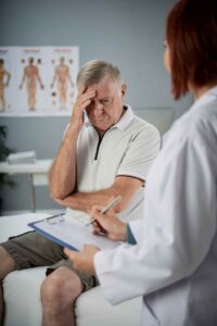 Friendly doctor examining female patient during wellness checkup