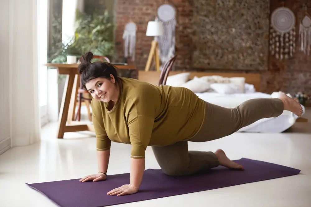 Woman exercising indoors on yoga mat strengthening muscles