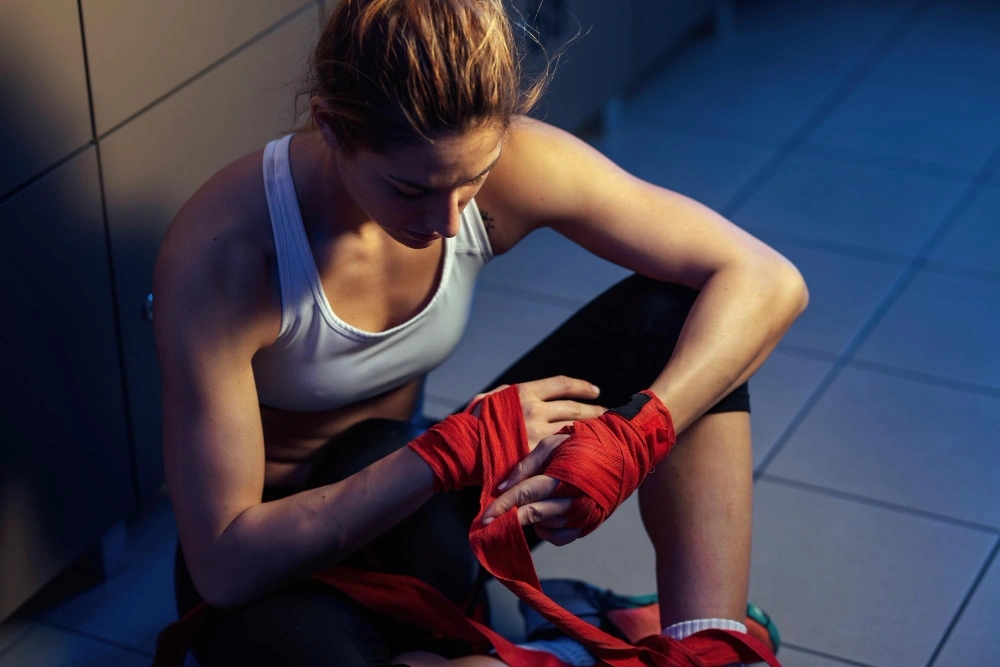 Female boxer with hand injury during sports training