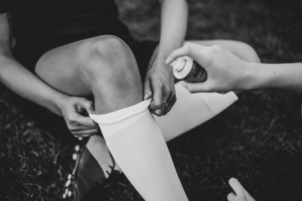 Female soccer player holding knee after sports injury