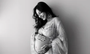 Pregnant woman holding lower back due to pregnancy-related pain