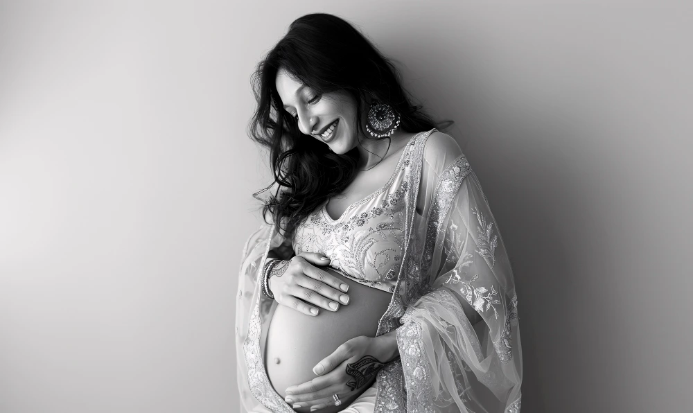 Pregnant woman holding lower back due to pregnancy-related pain