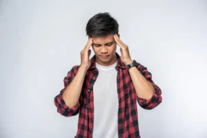 Man holding head due to migraine or severe headache