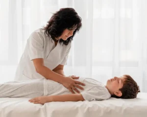Pediatric chiropractor gently treating a child to support spinal health and overall development