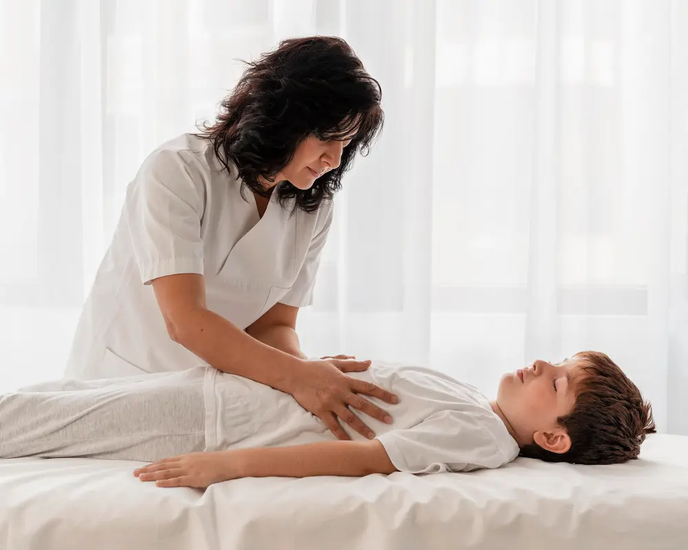 Pediatric chiropractor gently treating a child to support spinal health and overall development