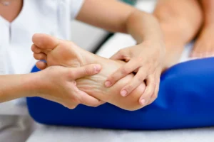 Person experiencing heel and foot pain from plantar fasciitis