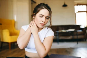 Person experiencing neck pain with numbness and tingling in arm and hand