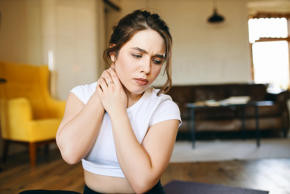 Person experiencing neck pain with numbness and tingling in arm and hand