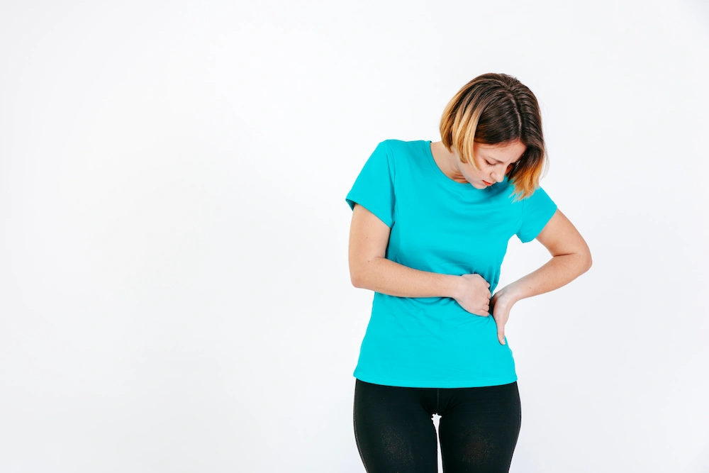 Woman holding outer hip in pain due to inflammation and movement discomfort
