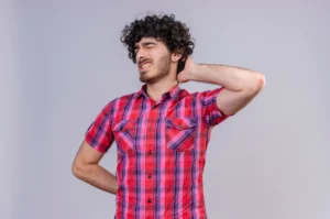 Stressed person holding their neck and shoulders at work